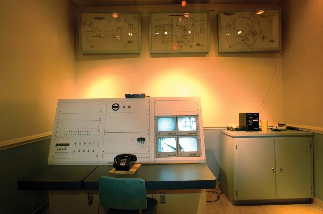 The security control room inside the Greenbrier bunker, with wall-mounted alarm-system diagrams and a monitoring console