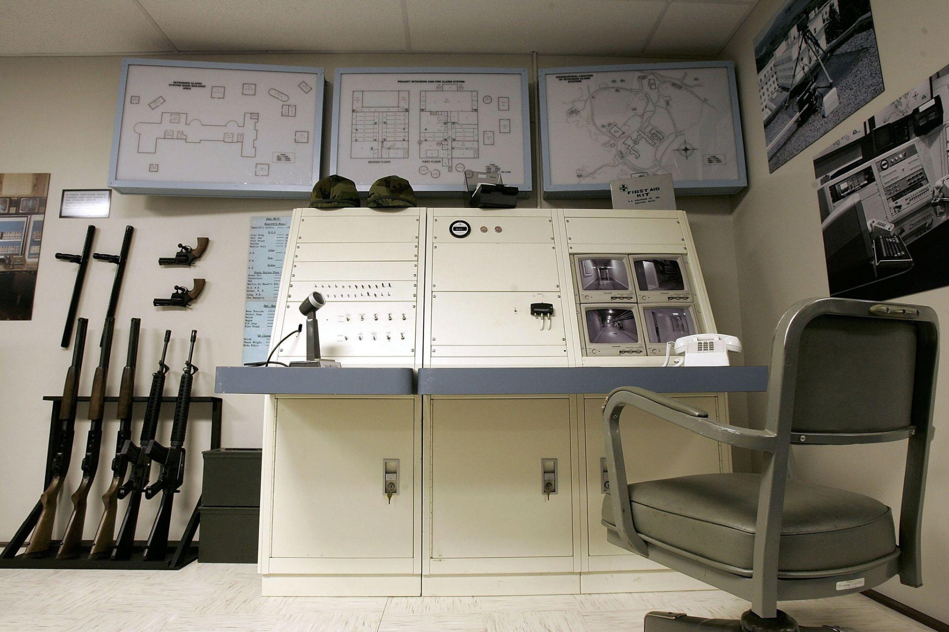 A period security console inside the Greenbrier bunker with closed-circuit monitors, alongside a display of the security equipment the facility kept on hand