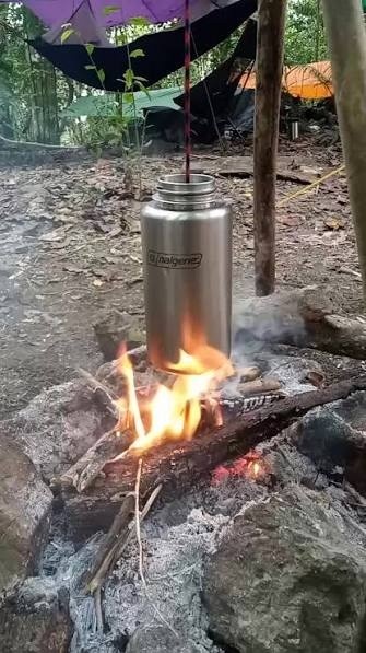 Stainless steel Nalgene 1L boiling water over a fire